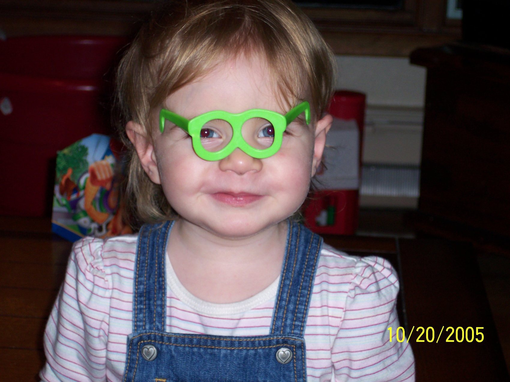 Young Abbi wearing playful green glasses